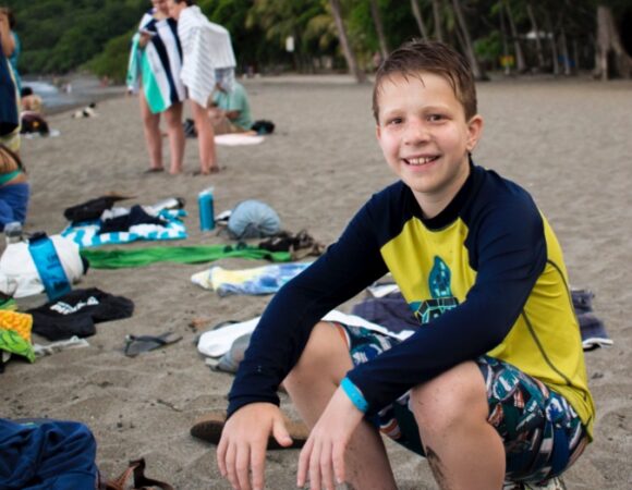 student-smiling-on-beach