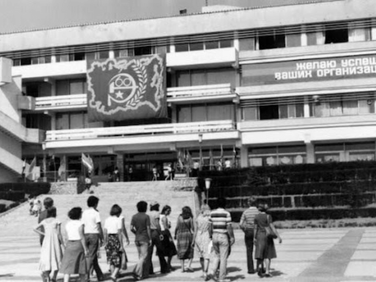 black and white old photo of group of students walking away