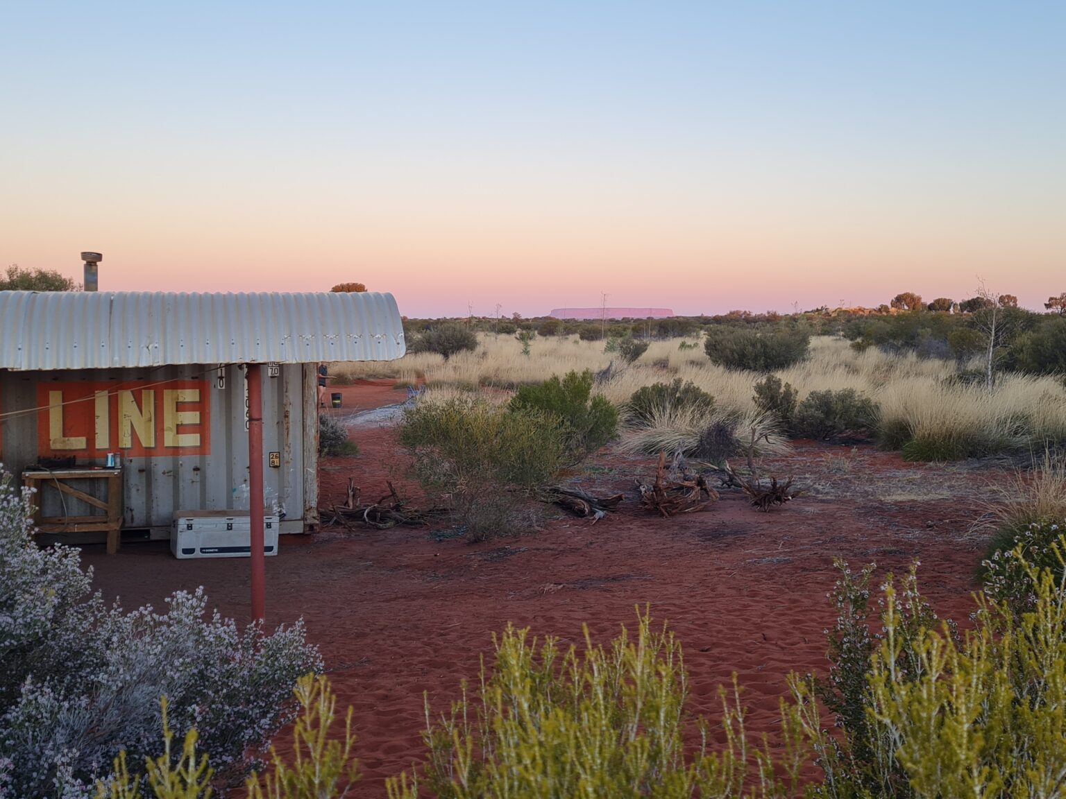 Landscape image of building and plants in the Outback