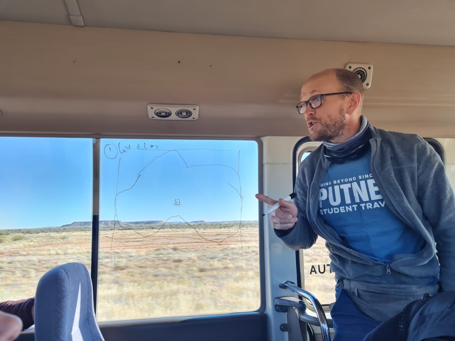 Putney leader points out a map drawn on a bus window