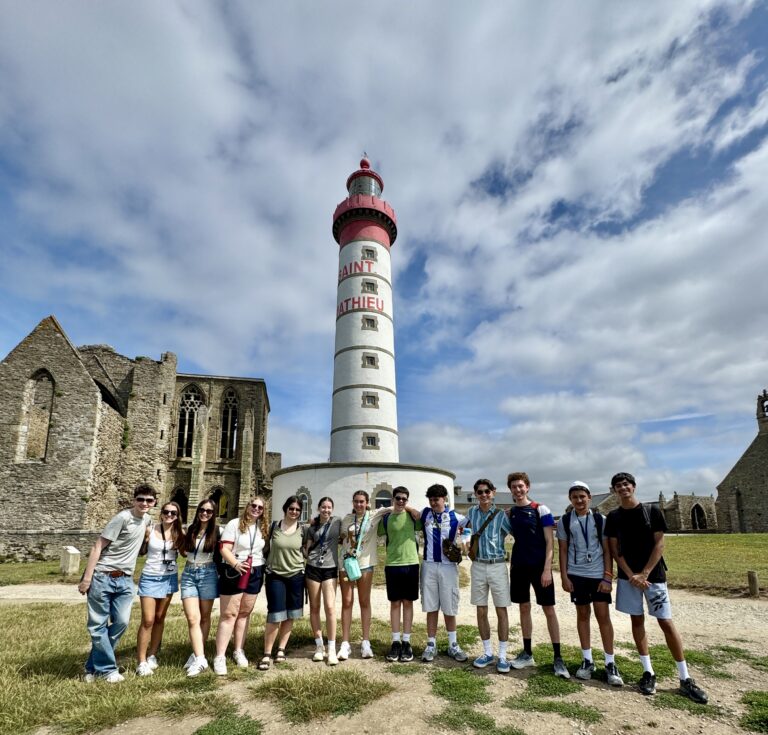 Students stand for group photo in front of St. Mathieu lighthouse in Le Conquet. 