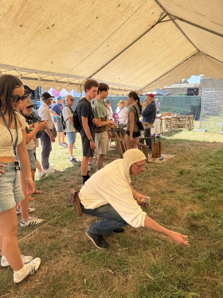 Local man show students how to play game at Festival of the West in Le Conquet. 