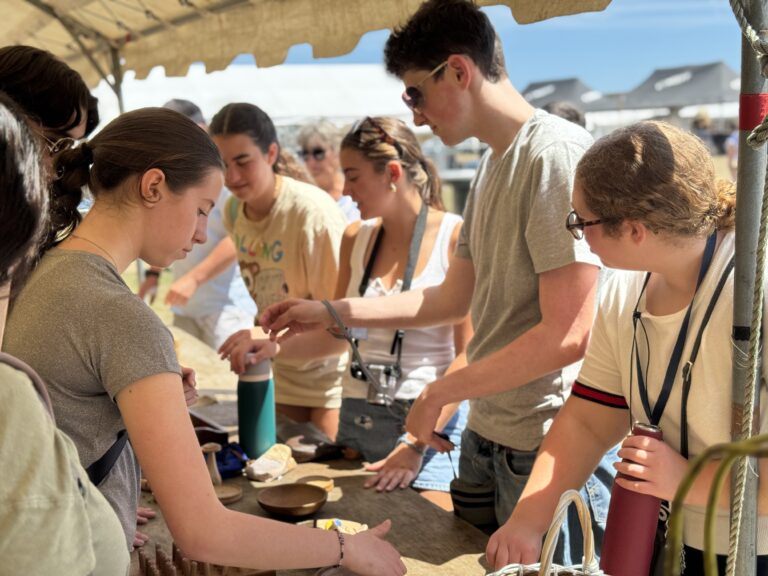 Students interacting with local artisans at Festival of the West in Le Conquet. 