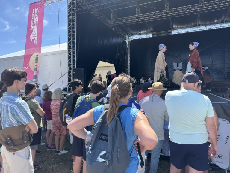 Students gathering at crowded stage at Festival of the West in Le Conquet.