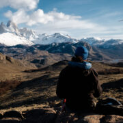 Sitting student looks out at Patagonian mountain landscape