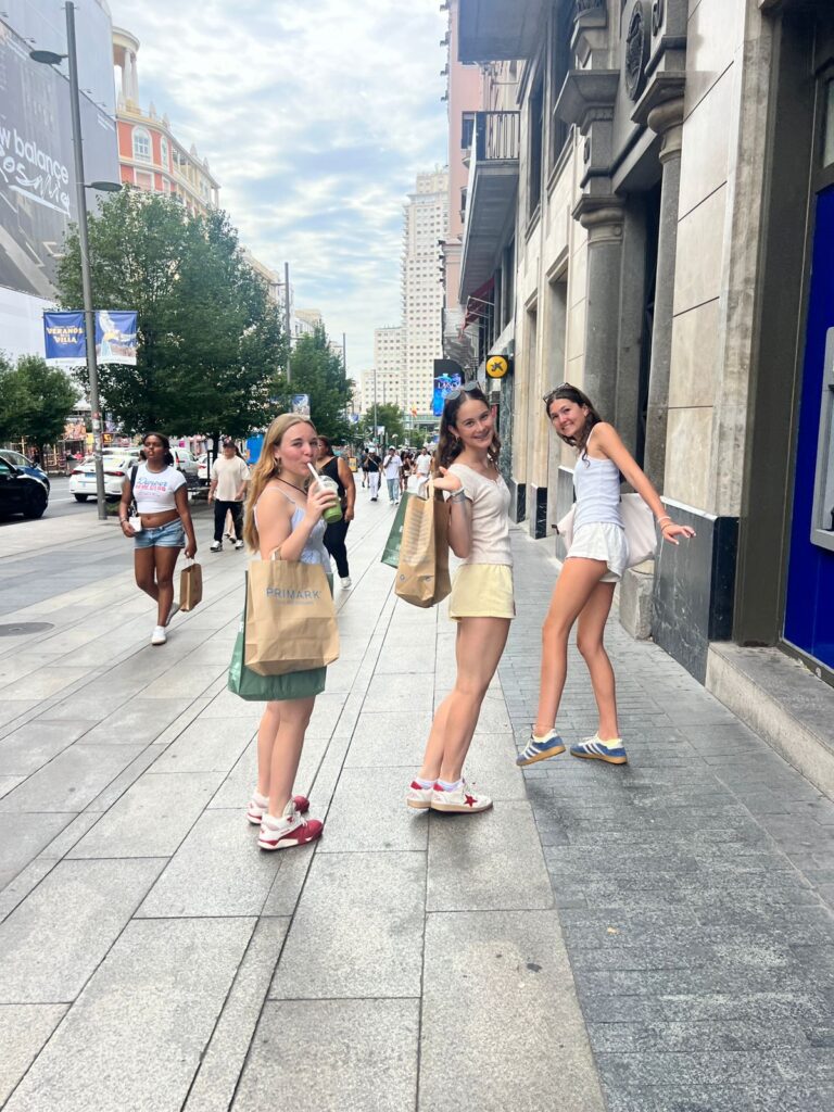 Three students stand on the street in Madrid