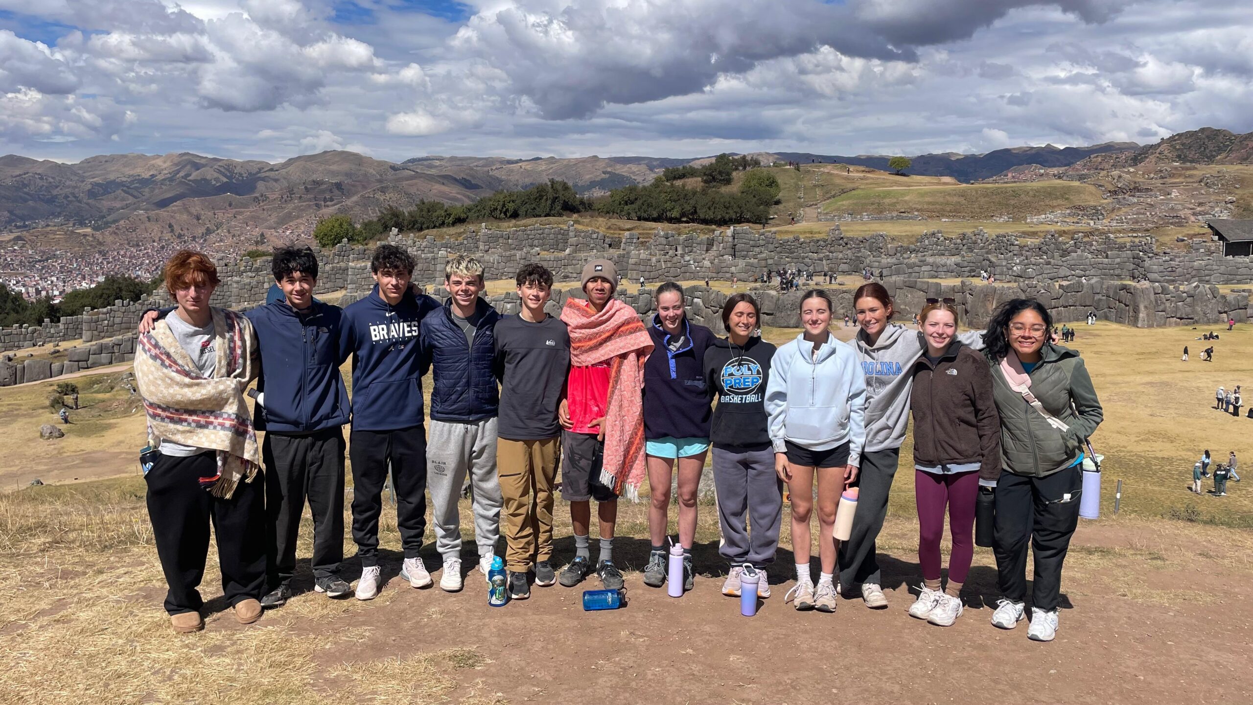 Group photo of student outside in the mountains at historic ruins site in Peru