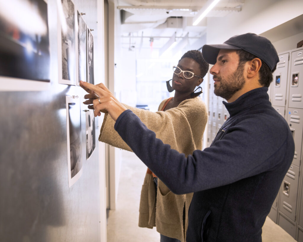 ICP Student and teacher look at photos